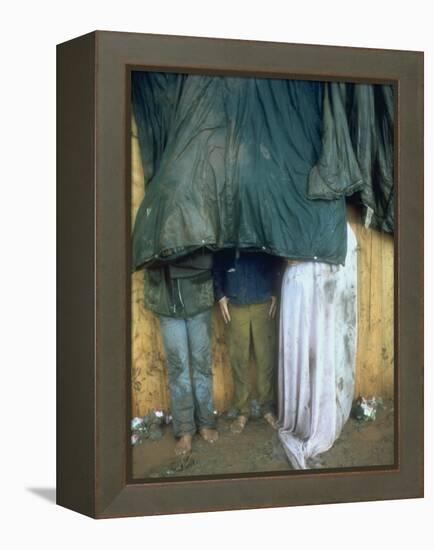 Taking Shelter from the Storm at Woodstock-Bill Eppridge-Framed Premier Image Canvas