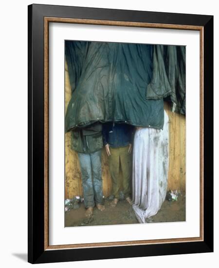 Taking Shelter from the Storm at Woodstock-Bill Eppridge-Framed Photographic Print