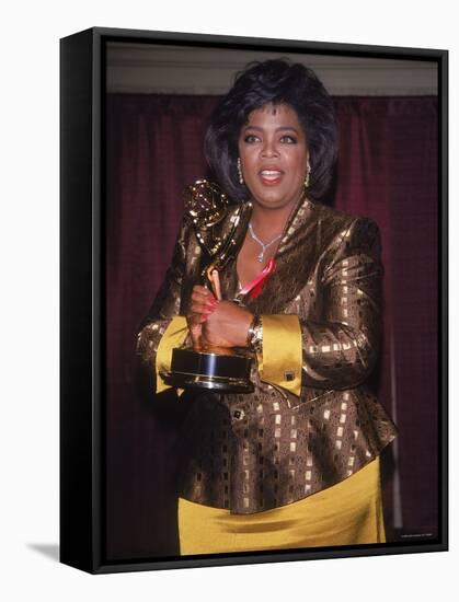 Talk Show Host Oprah Winfrey Holding Emmy Award-null-Framed Premier Image Canvas