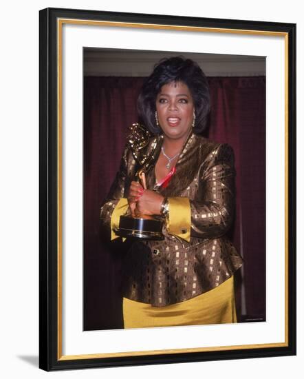 Talk Show Host Oprah Winfrey Holding Emmy Award-null-Framed Premium Photographic Print