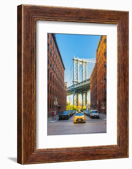 Taxi passing under the Manhattan bridge with the Empire state building framed in the bridge, New Yo-Jordan Banks-Framed Photographic Print