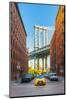 Taxi passing under the Manhattan bridge with the Empire state building framed in the bridge, New Yo-Jordan Banks-Mounted Photographic Print