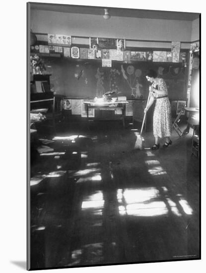 Teacher stays behind to give school final sweeping on the last day after everyone has gone home-Thomas D^ Mcavoy-Mounted Photographic Print