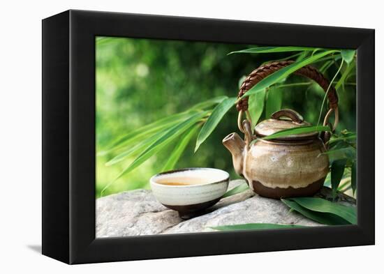 Teapot and Cups on Stone with Bamboo Leaves.-Liang Zhang-Framed Premier Image Canvas