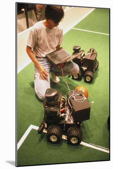 Technician Programs Robot Footballer At RoboCup-98-Volker Steger-Mounted Photographic Print