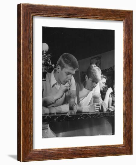 Teen Age Boys and Girls Drinking Milkshakes in Drug Store-Nina Leen-Framed Photographic Print