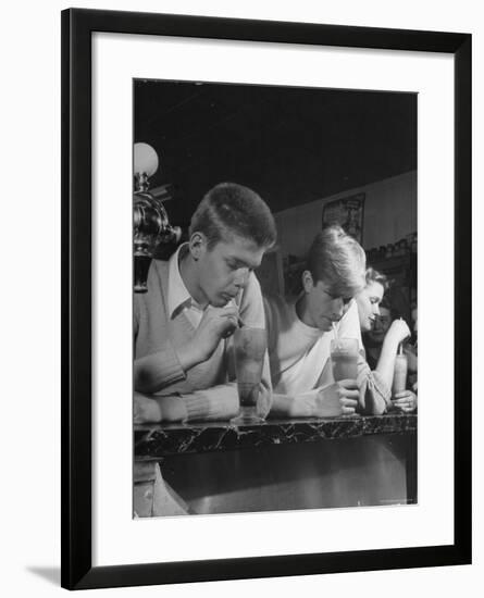 Teen Age Boys and Girls Drinking Milkshakes in Drug Store-Nina Leen-Framed Photographic Print