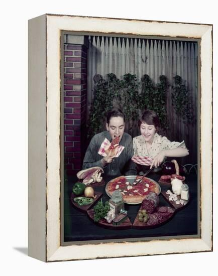 Teen Couple Eating Pizza from a Garden Table, 1960-Eliot Elisofon-Framed Premier Image Canvas