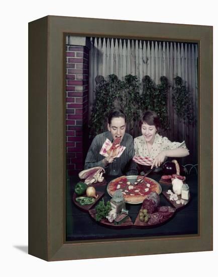 Teen Couple Eating Pizza from a Garden Table, 1960-Eliot Elisofon-Framed Premier Image Canvas