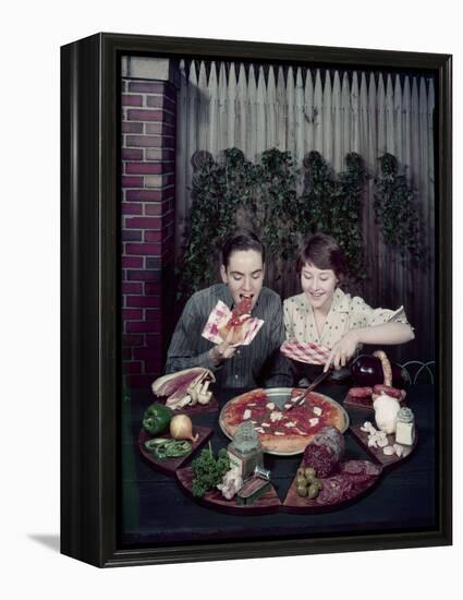 Teen Couple Eating Pizza from a Garden Table, 1960-Eliot Elisofon-Framed Premier Image Canvas