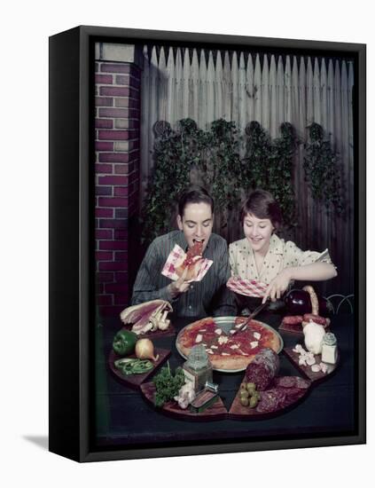 Teen Couple Eating Pizza from a Garden Table, 1960-Eliot Elisofon-Framed Premier Image Canvas