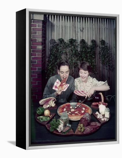 Teen Couple Eating Pizza from a Garden Table, 1960-Eliot Elisofon-Framed Premier Image Canvas