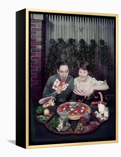 Teen Couple Eating Pizza from a Garden Table, 1960-Eliot Elisofon-Framed Premier Image Canvas