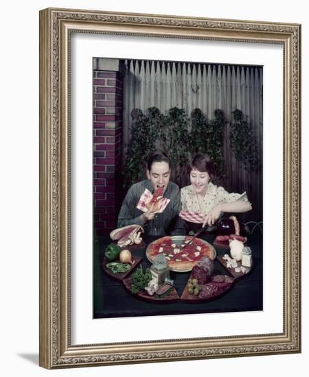 Teen Couple Eating Pizza from a Garden Table, 1960-Eliot Elisofon-Framed Photographic Print