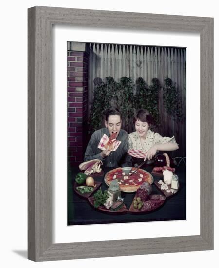 Teen Couple Eating Pizza from a Garden Table, 1960-Eliot Elisofon-Framed Photographic Print