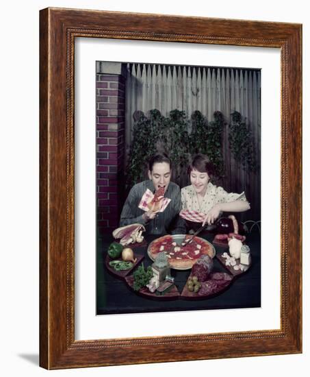 Teen Couple Eating Pizza from a Garden Table, 1960-Eliot Elisofon-Framed Photographic Print