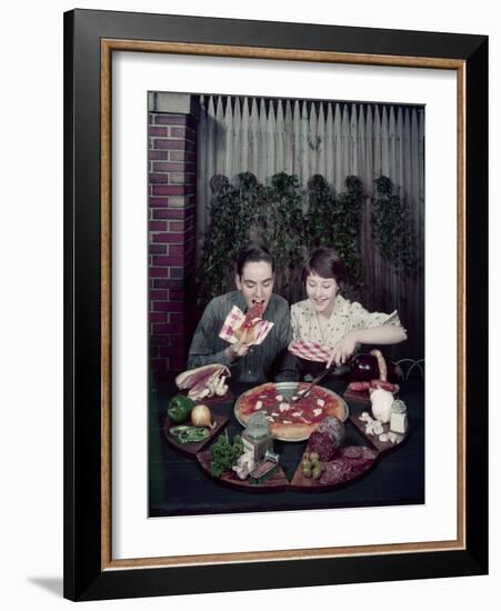 Teen Couple Eating Pizza from a Garden Table, 1960-Eliot Elisofon-Framed Photographic Print