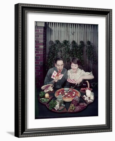 Teen Couple Eating Pizza from a Garden Table, 1960-Eliot Elisofon-Framed Photographic Print