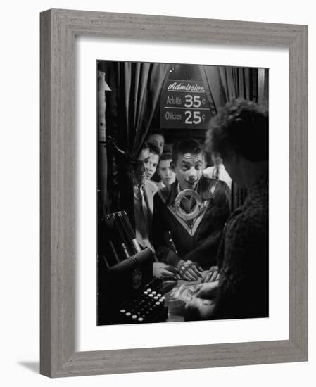 Teenage Boy Peering Into Window of Ticket Booth at a Movie Theater-Yale Joel-Framed Photographic Print