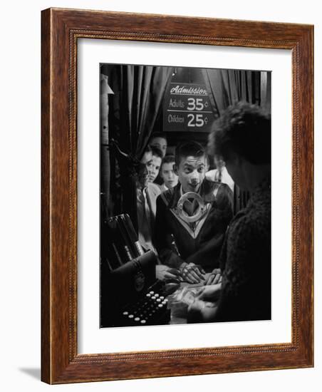 Teenage Boy Peering Into Window of Ticket Booth at a Movie Theater-Yale Joel-Framed Photographic Print