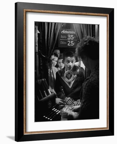 Teenage Boy Peering Into Window of Ticket Booth at a Movie Theater-Yale Joel-Framed Photographic Print