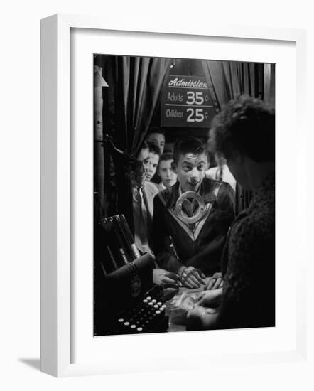 Teenage Boy Peering Into Window of Ticket Booth at a Movie Theater-Yale Joel-Framed Photographic Print