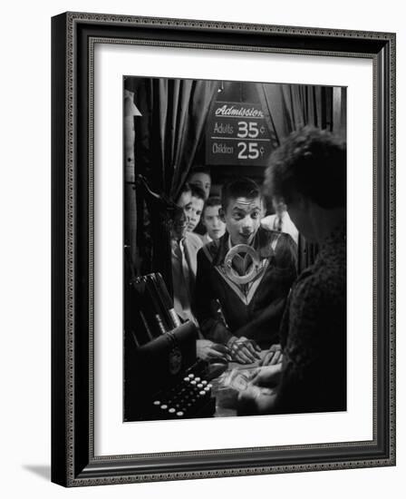 Teenage Boy Peering Into Window of Ticket Booth at a Movie Theater-Yale Joel-Framed Photographic Print