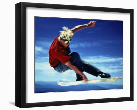 Teenage Boy Snowboarding in Mid-Air-null-Framed Photographic Print