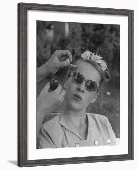 Teenage Girl Having Nail Polish Touches Added to Her Sunglasses-Nina Leen-Framed Photographic Print