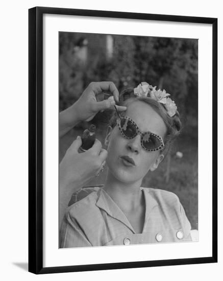 Teenage Girl Having Nail Polish Touches Added to Her Sunglasses-Nina Leen-Framed Photographic Print