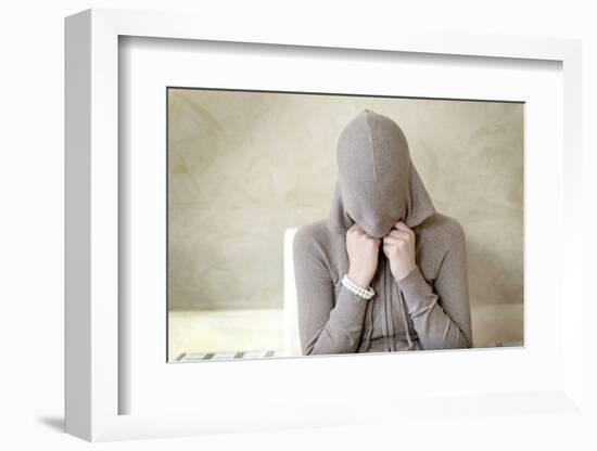 Teenage Girl Putting on Hoodie, Portrait-Axel Schmies-Framed Photographic Print
