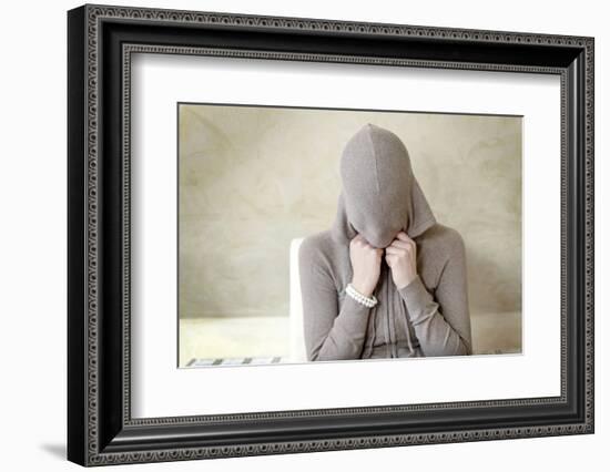 Teenage Girl Putting on Hoodie, Portrait-Axel Schmies-Framed Photographic Print