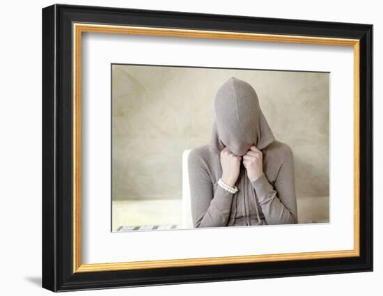 Teenage Girl Putting on Hoodie, Portrait-Axel Schmies-Framed Photographic Print