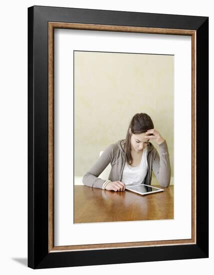 Teenage Girl Sitting with Digital Tablet at the Table, Portrait-Axel Schmies-Framed Photographic Print
