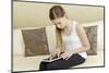 Teenage Girl Sitting with Digital Tablet on Sofa, Portrait-Axel Schmies-Mounted Photographic Print