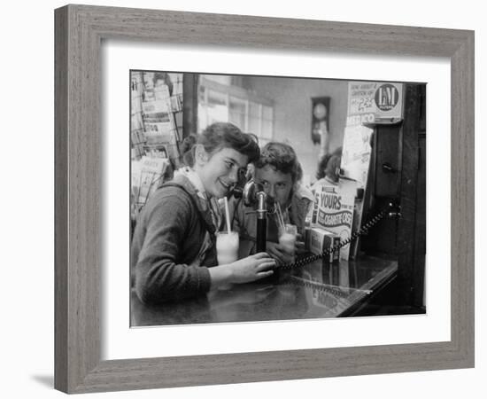 Teenage Girls Drinking Milkshakes at a Local Restaurant-Francis Miller-Framed Photographic Print