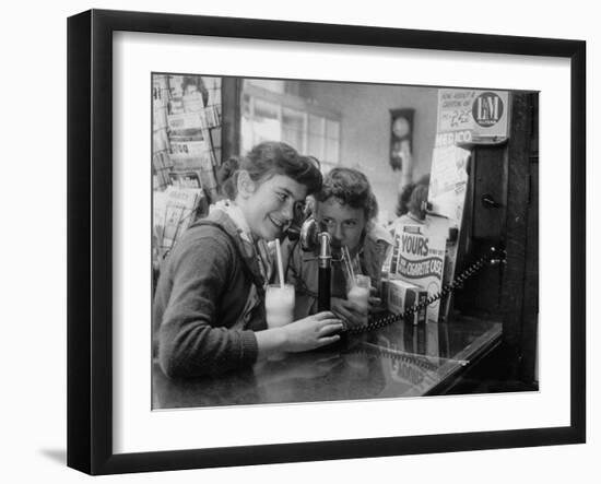 Teenage Girls Drinking Milkshakes at a Local Restaurant-Francis Miller-Framed Photographic Print