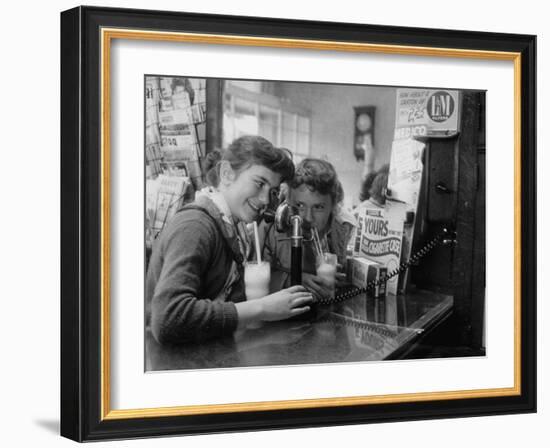 Teenage Girls Drinking Milkshakes at a Local Restaurant-Francis Miller-Framed Photographic Print