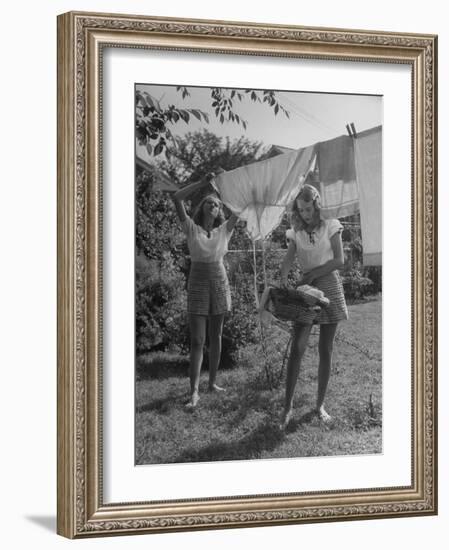 Teenage Twin Girls Hanging Laundry on Clothesline-Nina Leen-Framed Photographic Print