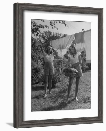 Teenage Twin Girls Hanging Laundry on Clothesline-Nina Leen-Framed Photographic Print