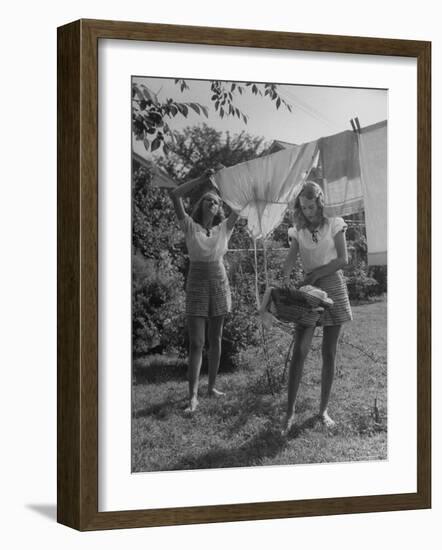 Teenage Twin Girls Hanging Laundry on Clothesline-Nina Leen-Framed Photographic Print