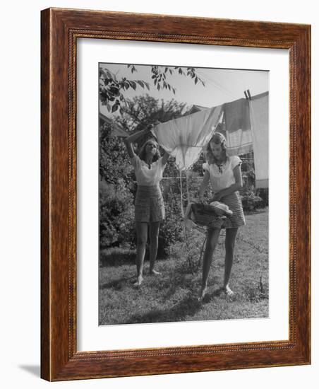 Teenage Twin Girls Hanging Laundry on Clothesline-Nina Leen-Framed Photographic Print