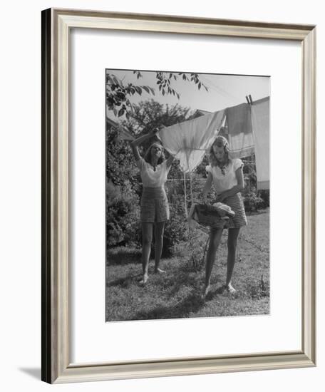 Teenage Twin Girls Hanging Laundry on Clothesline-Nina Leen-Framed Photographic Print