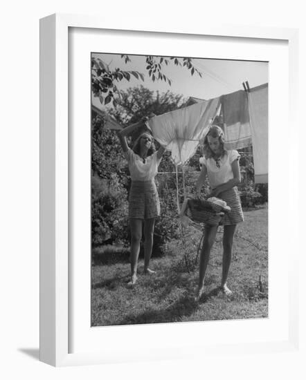 Teenage Twin Girls Hanging Laundry on Clothesline-Nina Leen-Framed Photographic Print