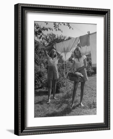 Teenage Twin Girls Hanging Laundry on Clothesline-Nina Leen-Framed Photographic Print