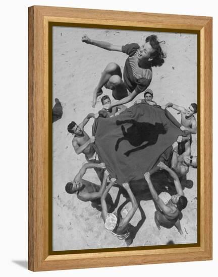 Teenaged Boys Using Blanket to Toss Their Friend, Norma Baker, Into the Air on the Beach-John Florea-Framed Premier Image Canvas