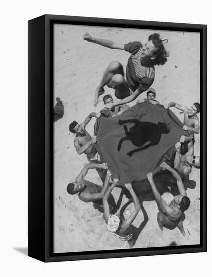 Teenaged Boys Using Blanket to Toss Their Friend, Norma Baker, Into the Air on the Beach-John Florea-Framed Premier Image Canvas