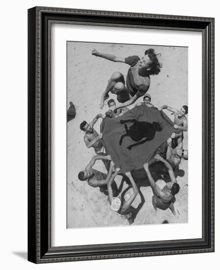 Teenaged Boys Using Blanket to Toss Their Friend, Norma Baker, Into the Air on the Beach-John Florea-Framed Photographic Print