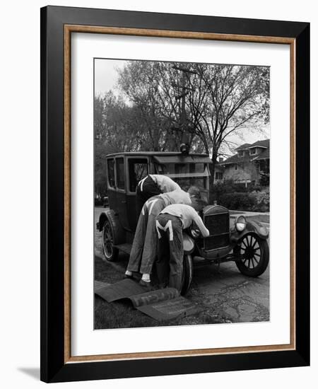 Teenaged Boys Working on a 1927 Ford Model T-Nina Leen-Framed Photographic Print