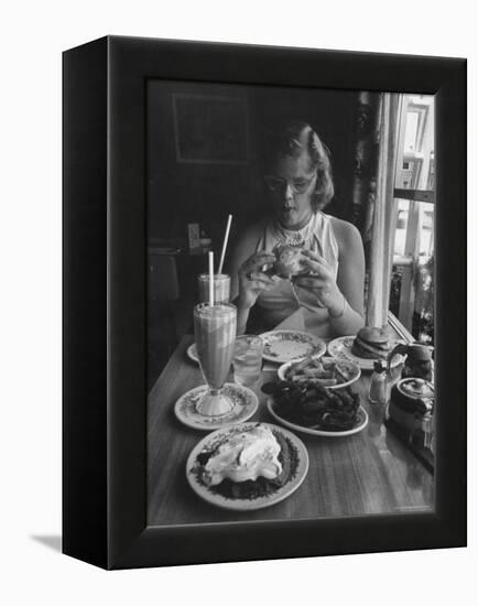 Teenaged Girl Sitting in Drugstore Eating a Hamburger-Hank Walker-Framed Premier Image Canvas